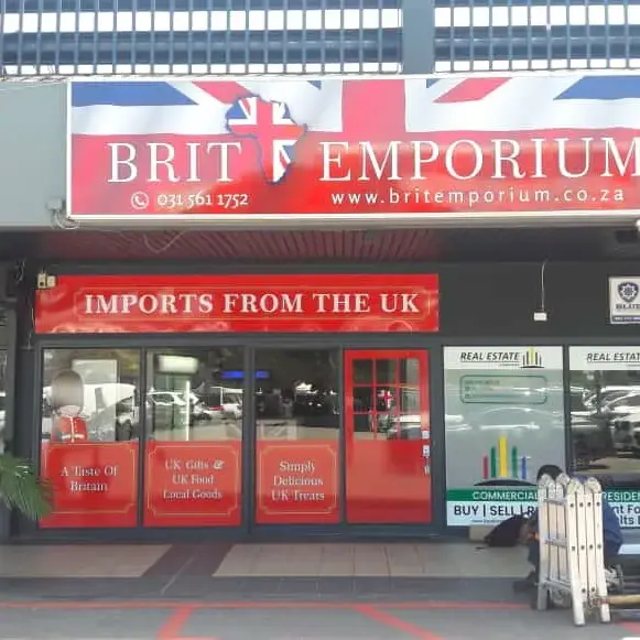 Complete retail shopfront branding combining exterior fascia signage, branded glass doors and promotional window graphics.