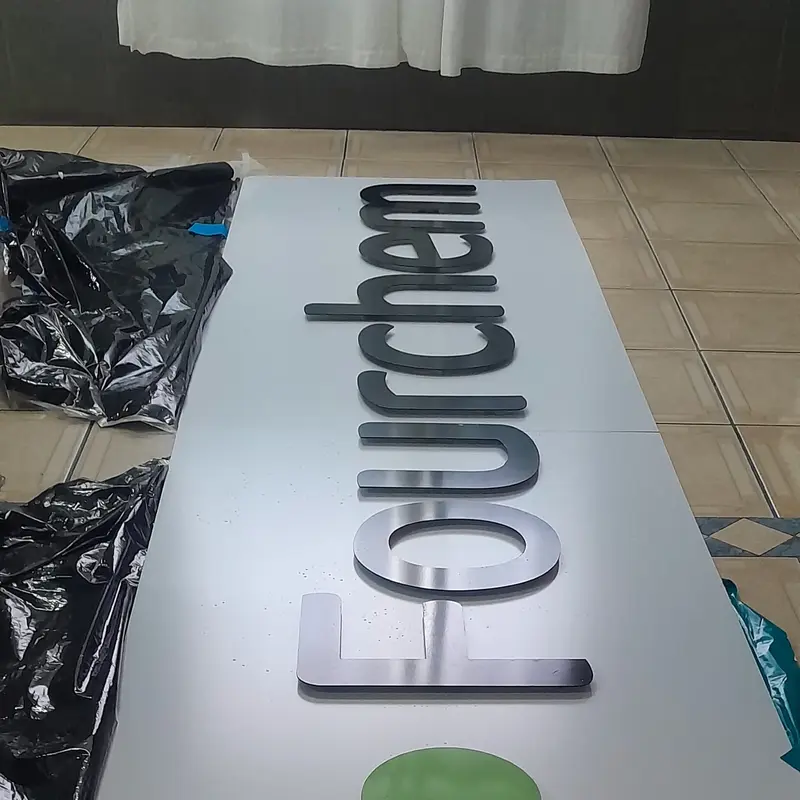 Custom exterior corporate logo signage featuring distinctive green dimensional graphics designed to strengthen business identity.