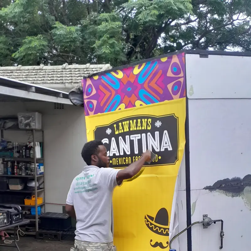 Professional food trailer branding installation featuring colourful graphics, business signage and custom printed vinyl.