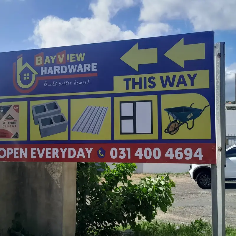 Custom outdoor directional and promotional signage featuring large arrows, high-contrast colours and business information for passing motorists.
