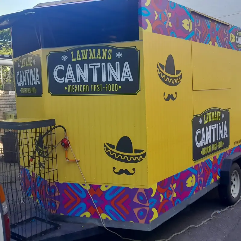 Complete mobile food trailer branding featuring custom graphics, business identification and decorative printed vinyl.