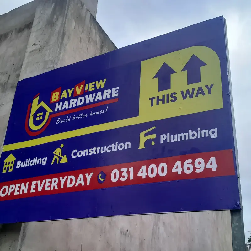 Custom commercial signage featuring bold printed graphics and business directions for effective outdoor brand visibility.